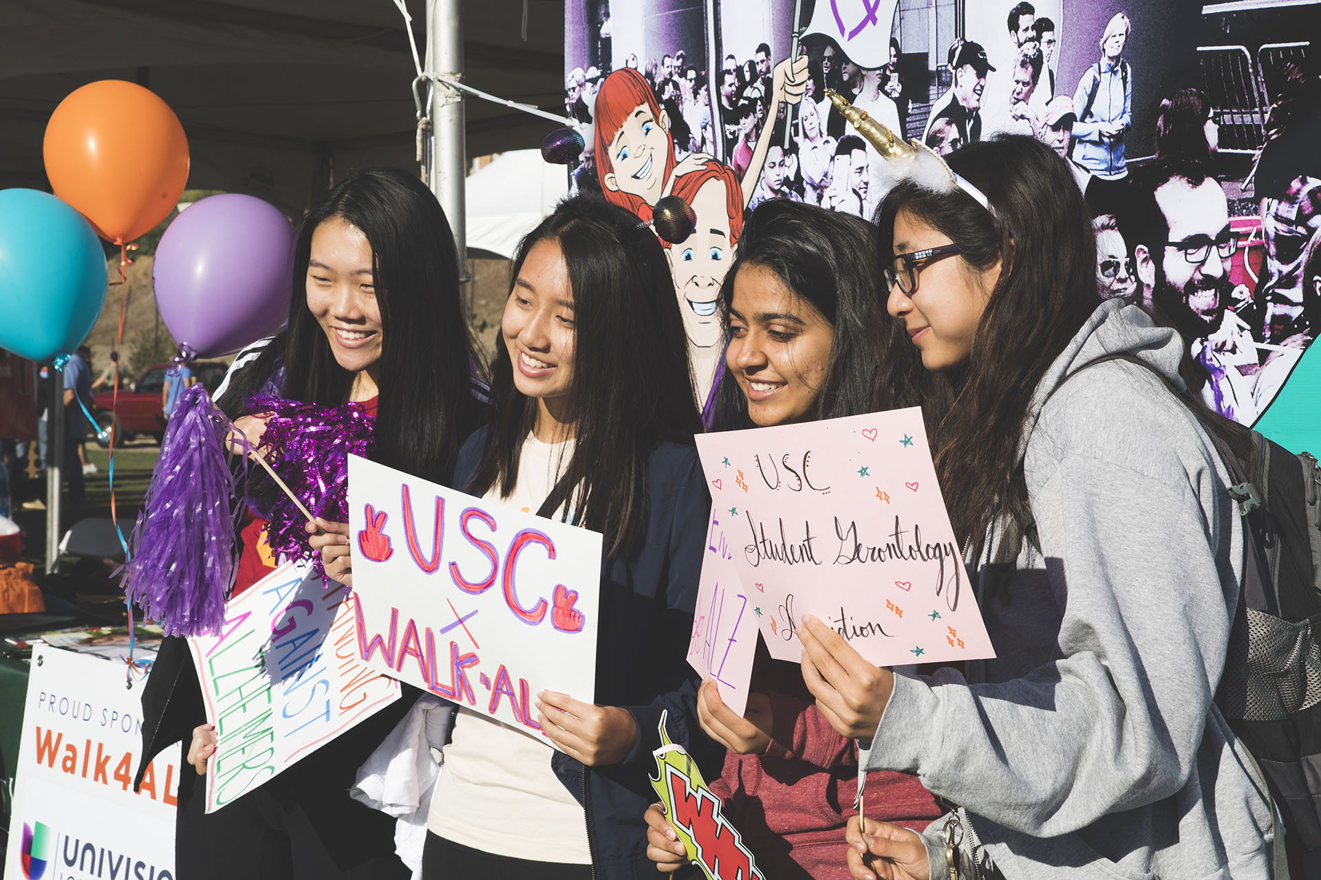 team of walkers from USC pose in front of social media booth