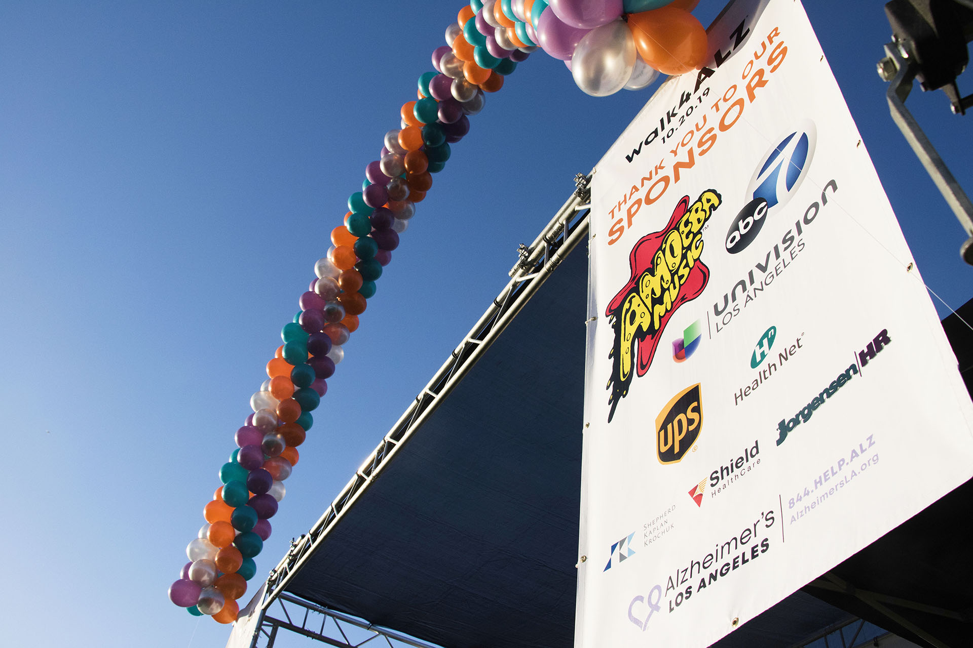 the stage with sponsor banner and balloons