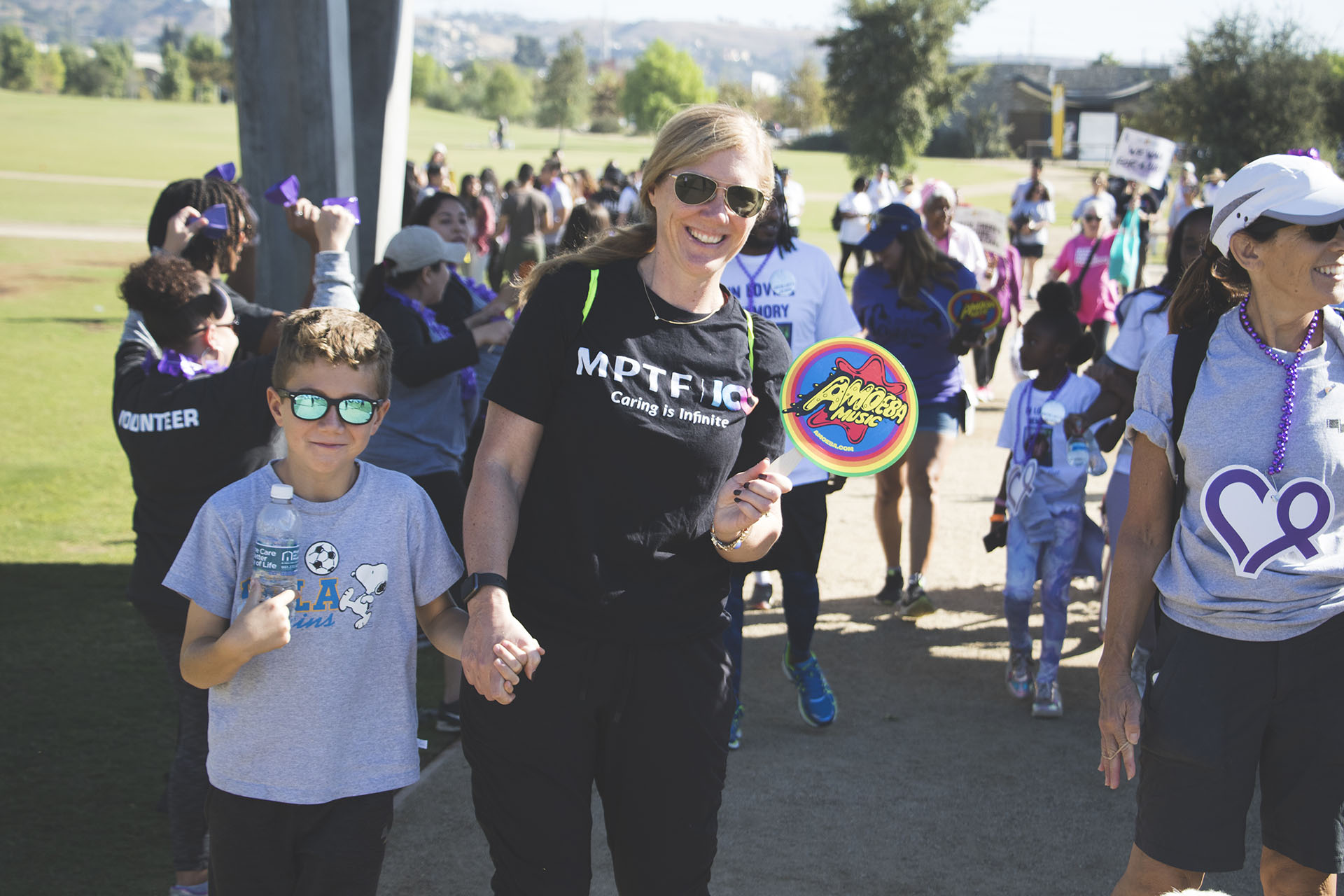 mother and young son walking under the start banner