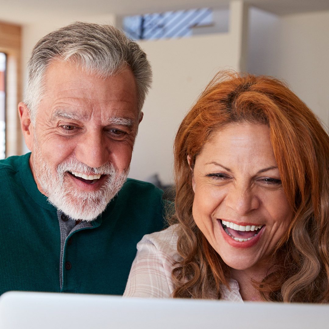 couple looking at computer screen, video chatting