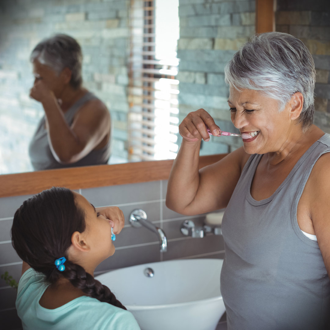 Daily-Activities–grooming grandmother and granddaughter brushing their teeth