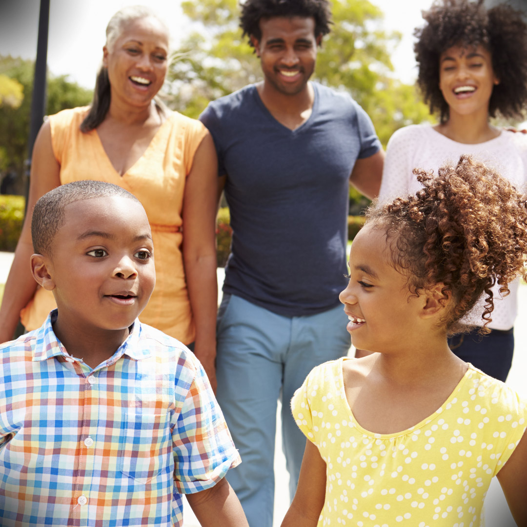 multigenerational African American family walking in park