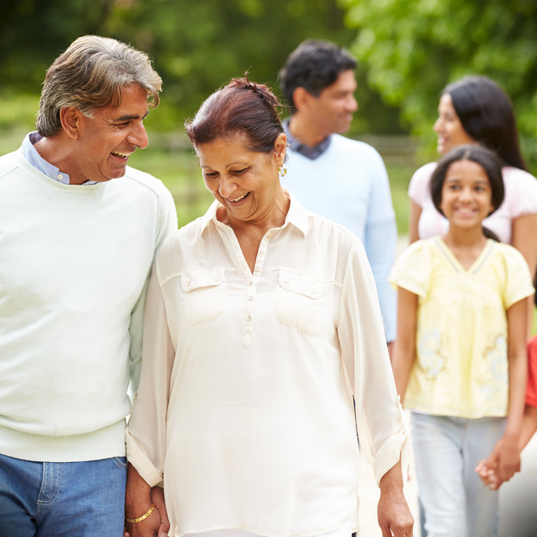 multigenerational Indian family walking in park