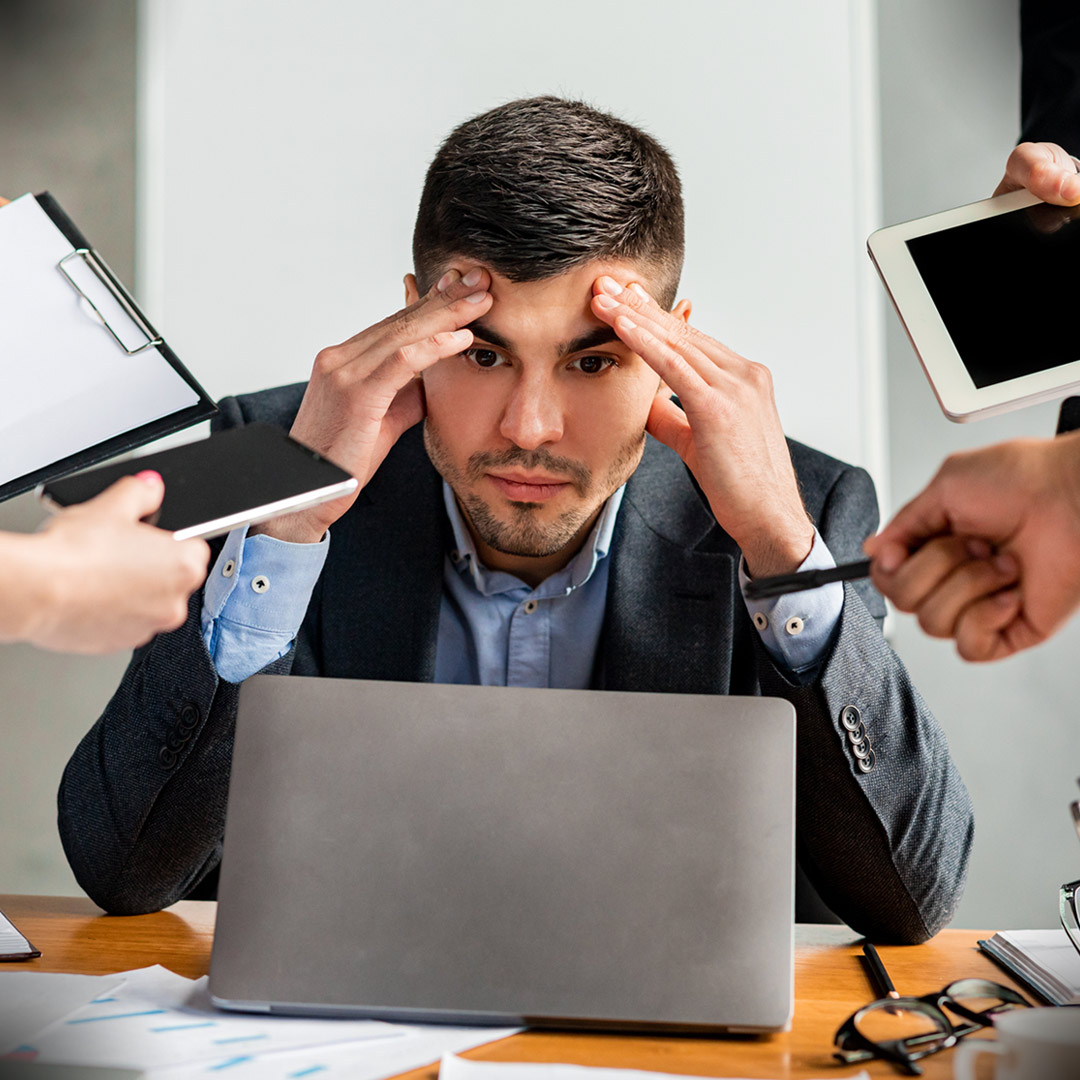 multiple hands giving stressed worker things to do