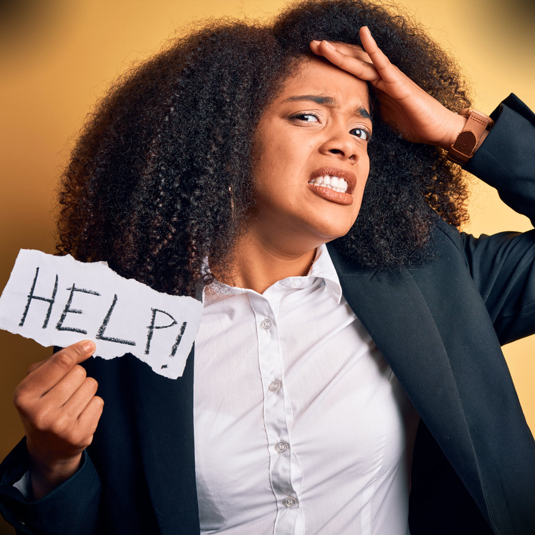 woman with worried look and holding Help! sign