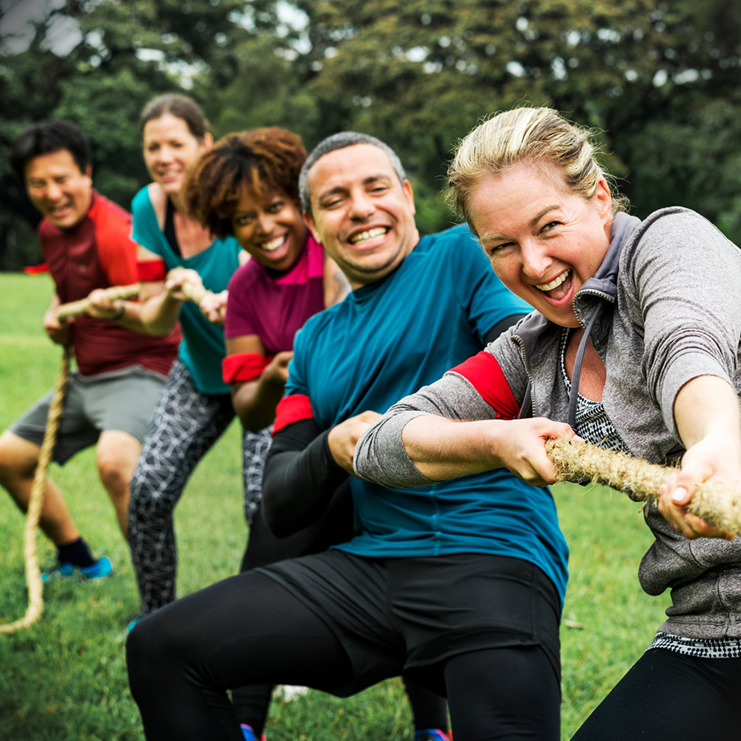 diverse adults on tug-of-war team