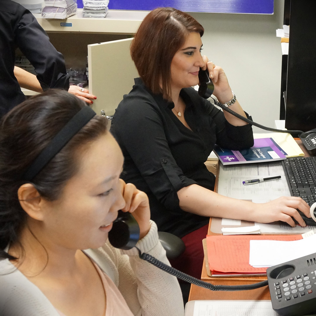 two Helpline volunteers on the phone at Alzheimer's Los Angeles