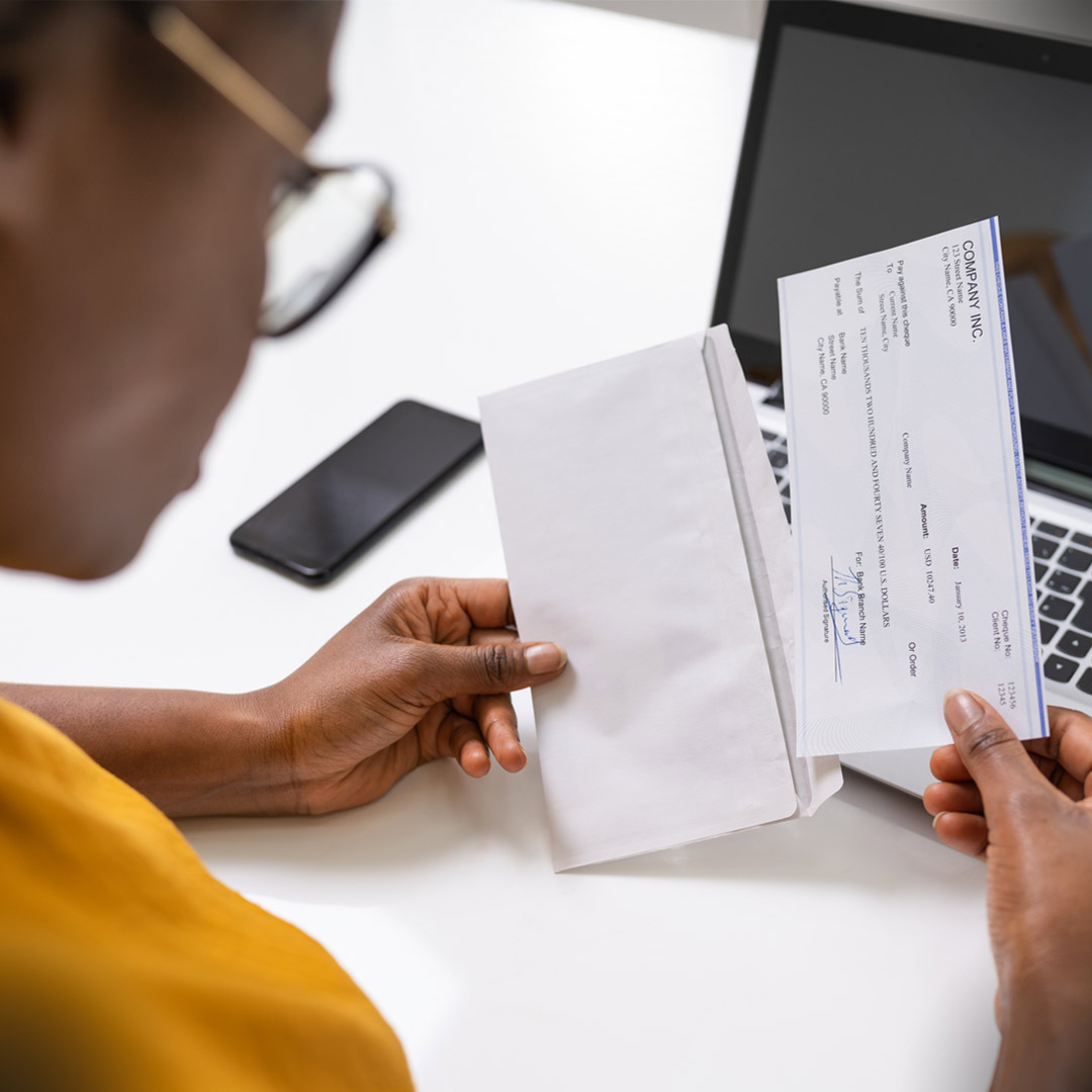 workplace-giving person looking at paycheck