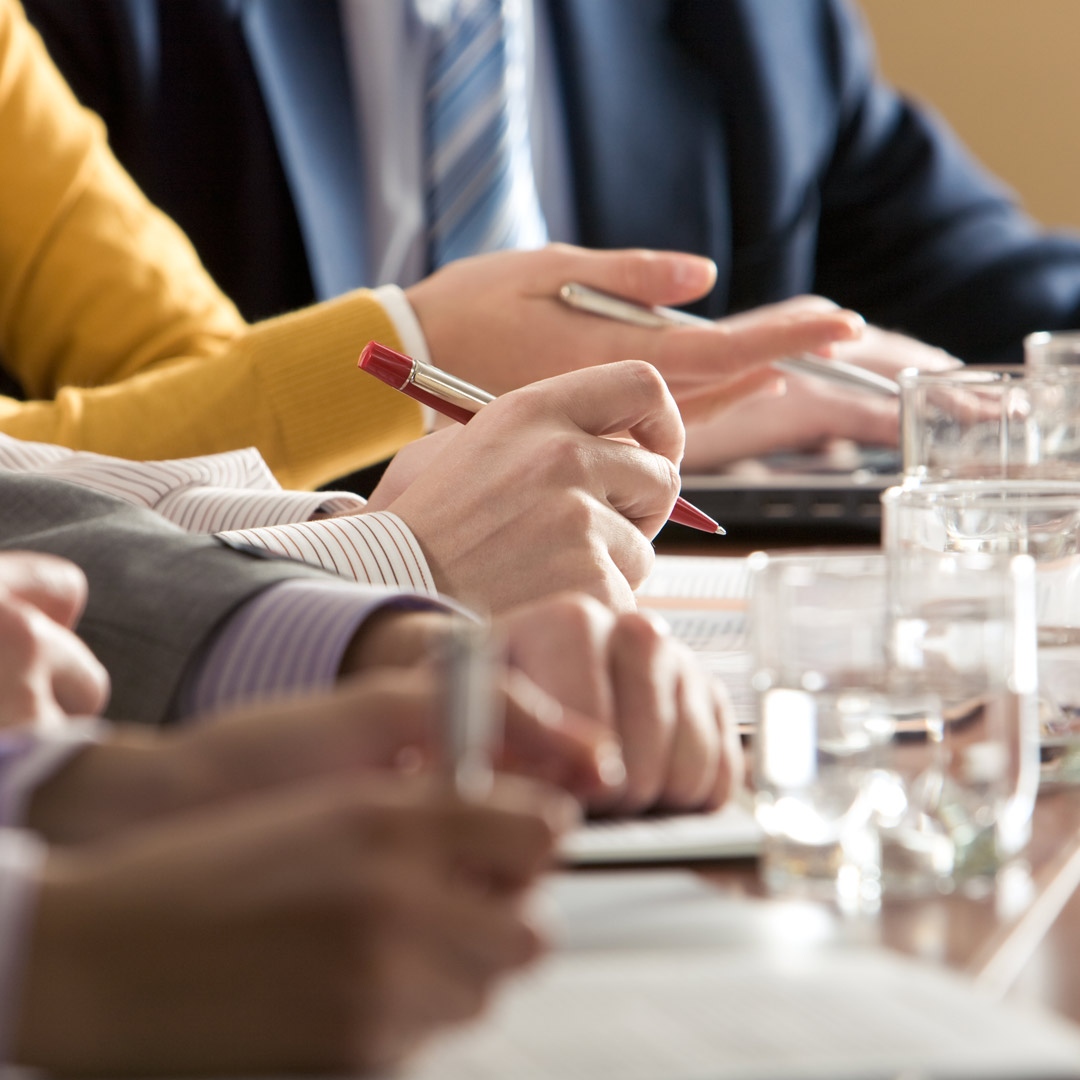 people taking notes at a business meeting