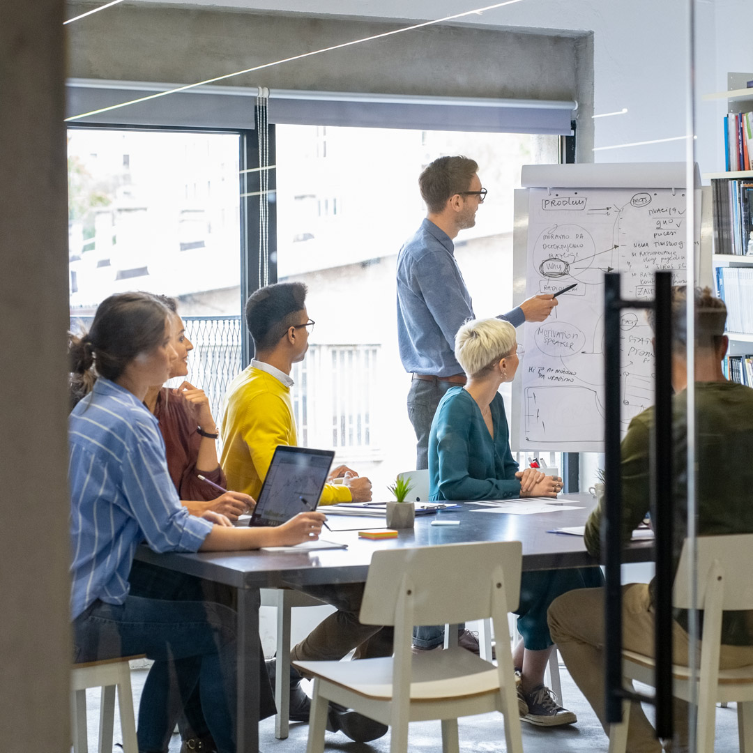 man giving presentation at casual business meeting