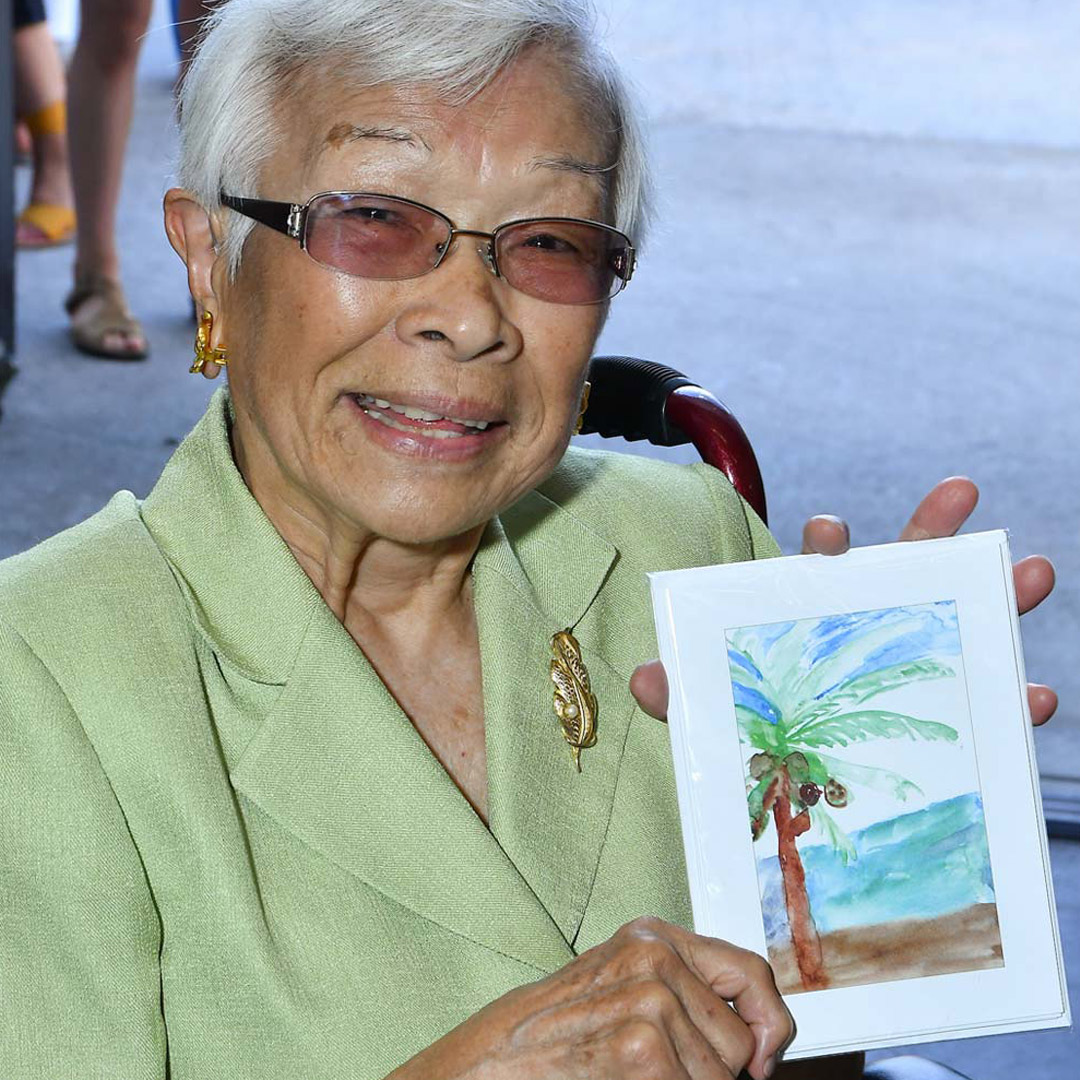 Memories in the Making participant holding her painting