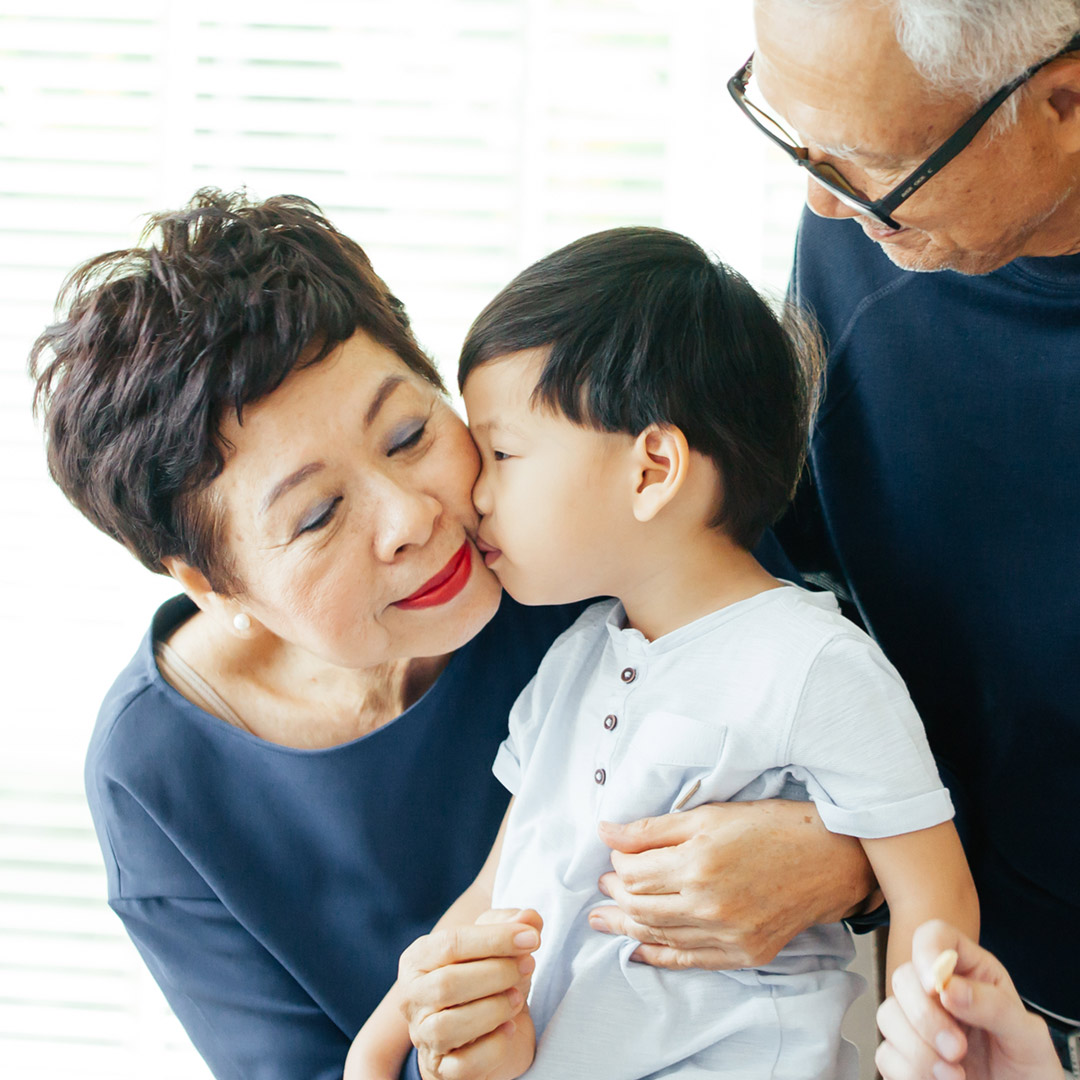 toddler kissing grandmother on the cheek