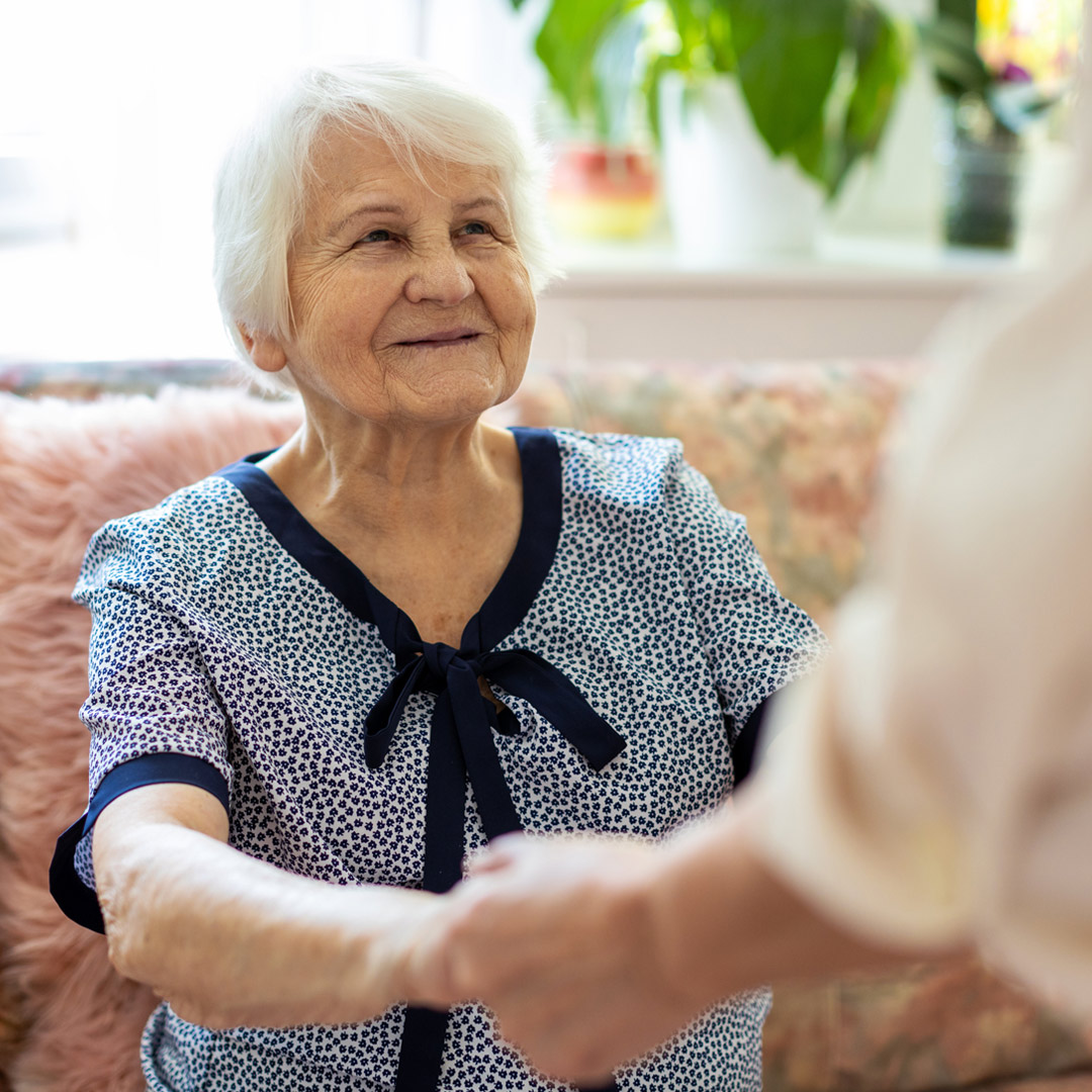 person helping woman to stand up