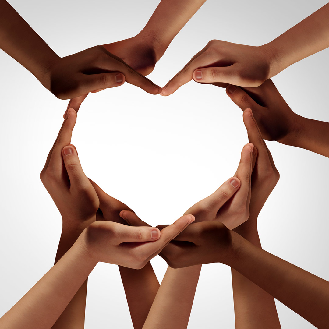 hands with differing skin tones coming together to form heart shape