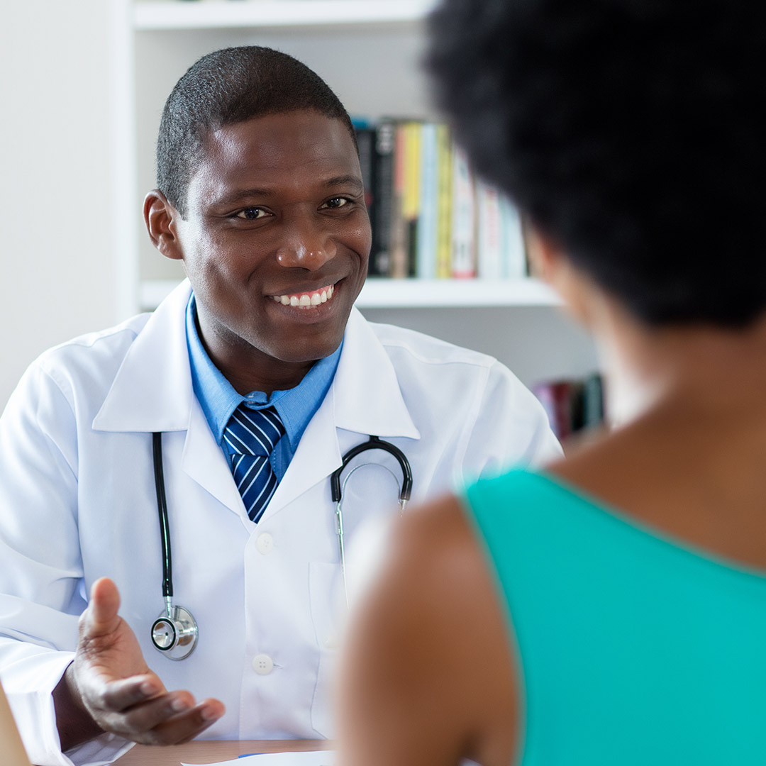 doctor smiling and talking with patient