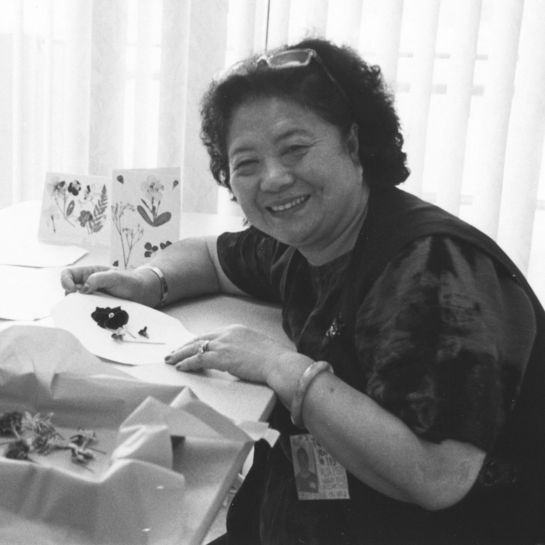 woman at senior center making crafts with dried flowers