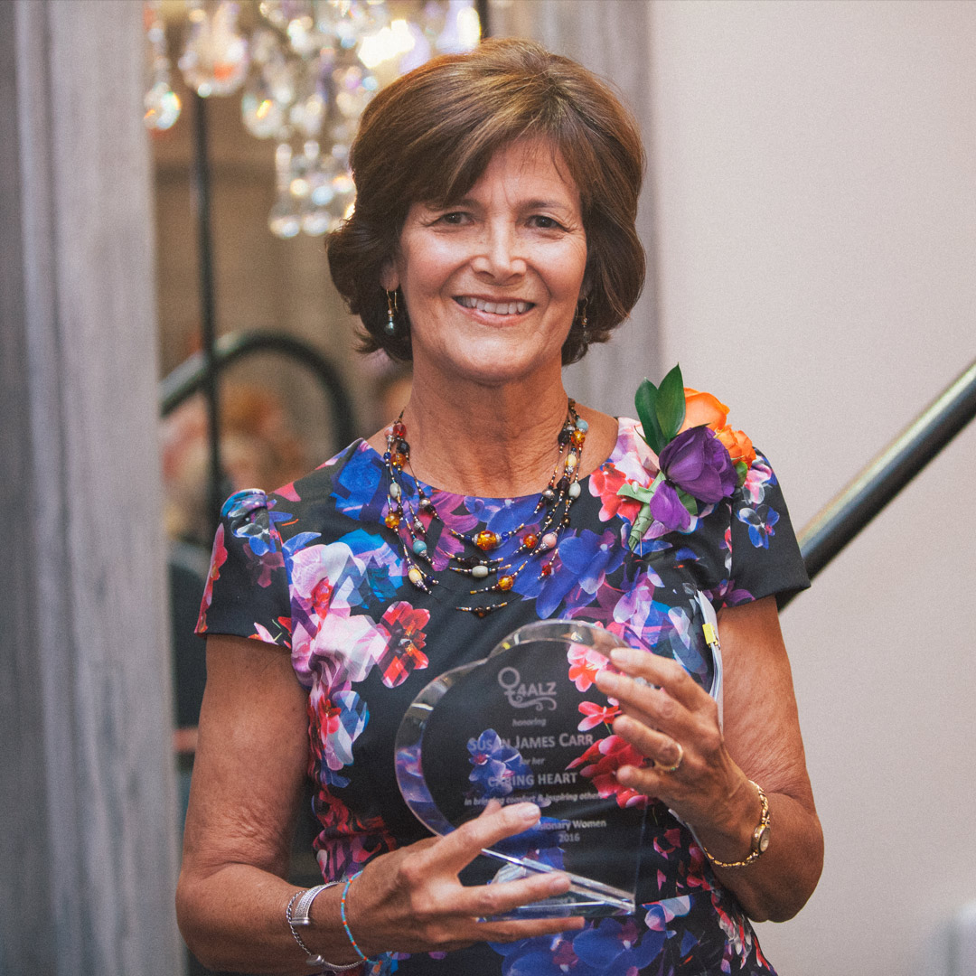 Susan Carr holds her Caring Heart Award 2016