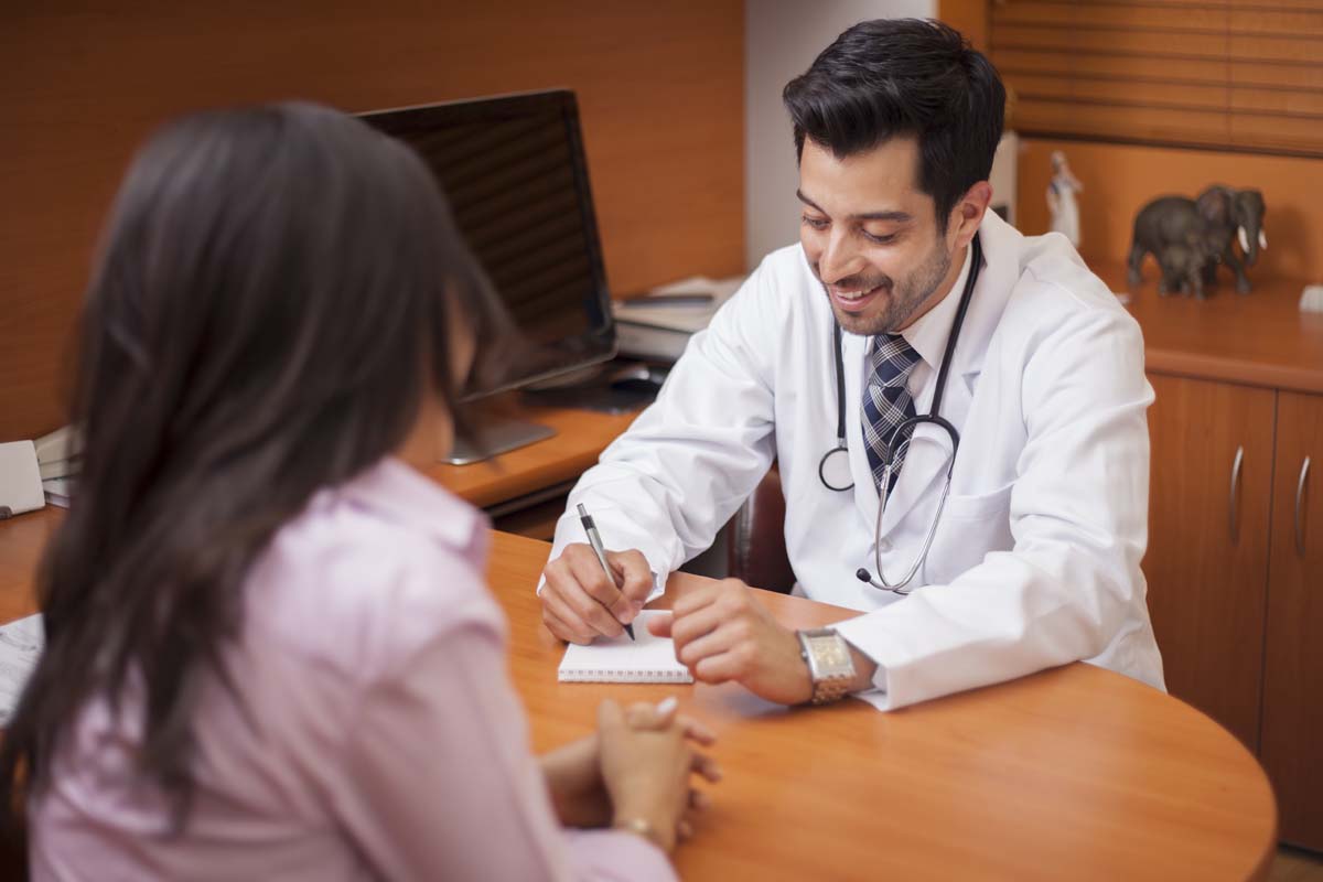 doctor talking with patient in medical office