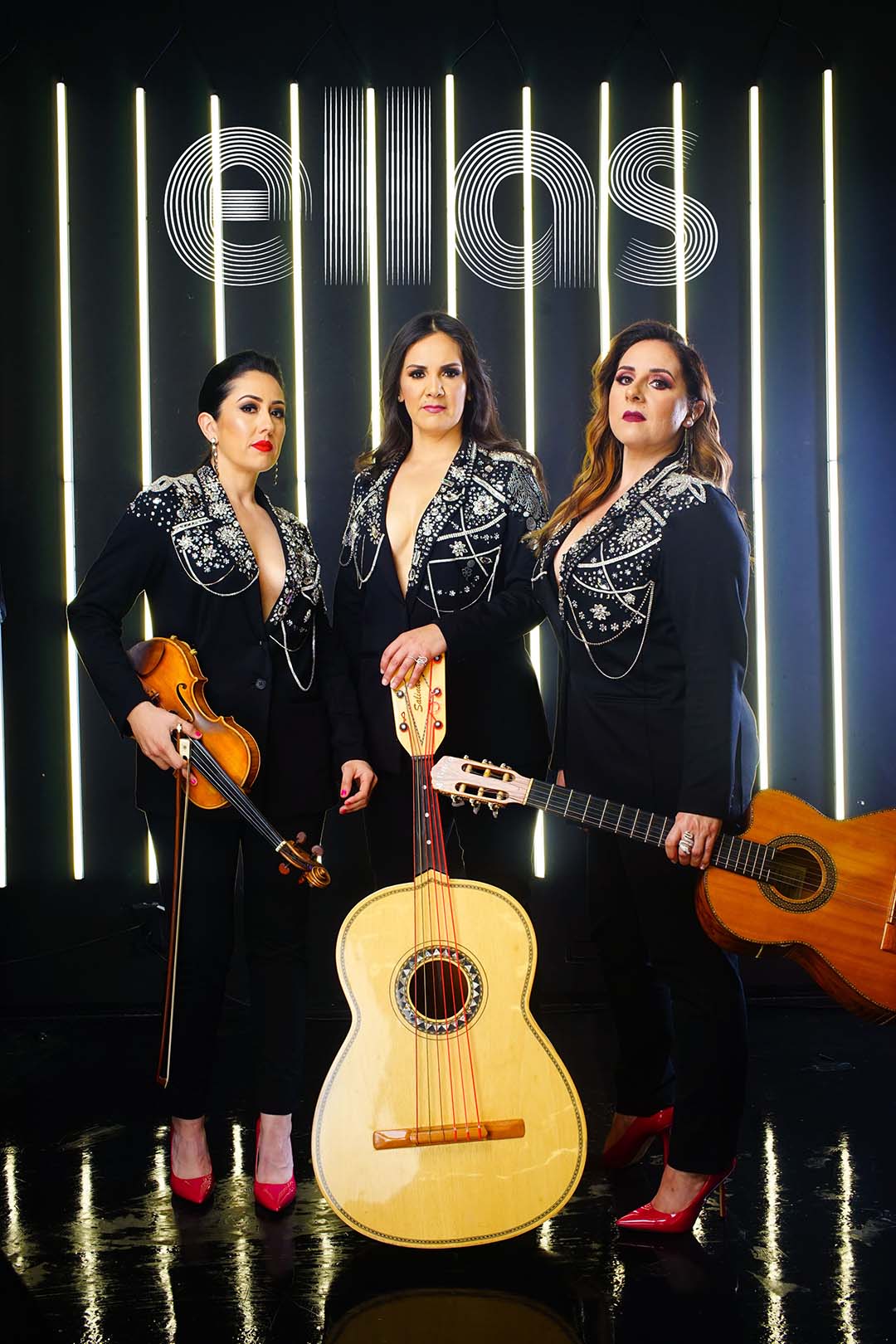 Ellas Ellas band members holding their musical instruments