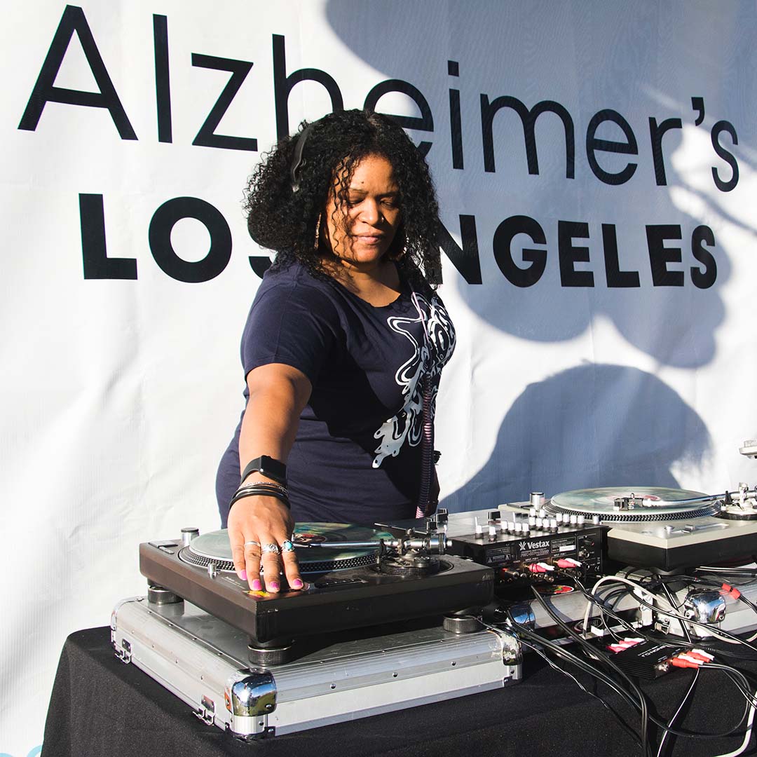 DJ Monalisa adjusting a turntable at walk4ALZ 2019