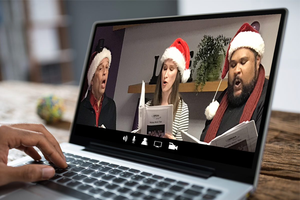computer screen showing LA Opera members dressed in Santa hats and singing
