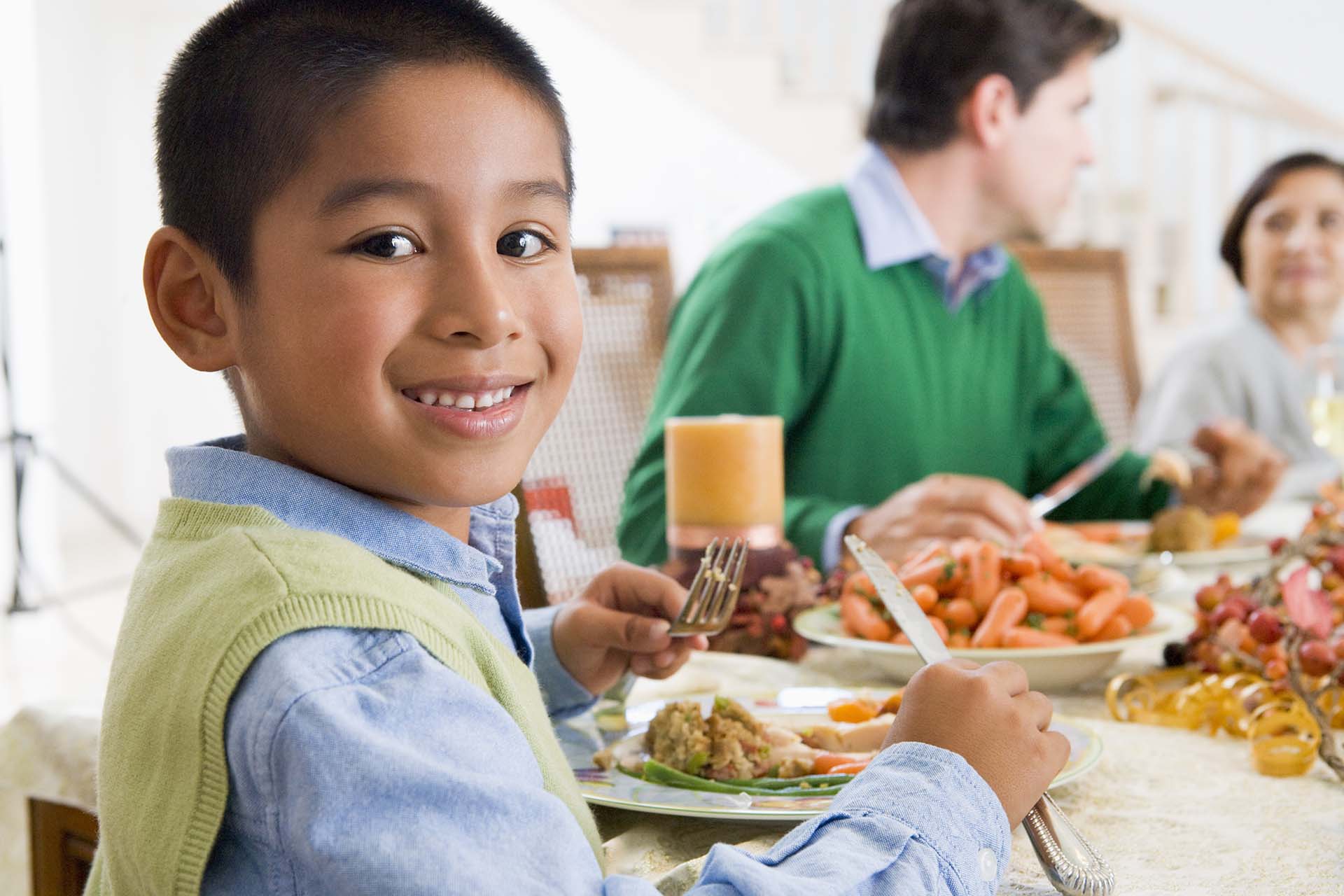 family eating holiday dinner together