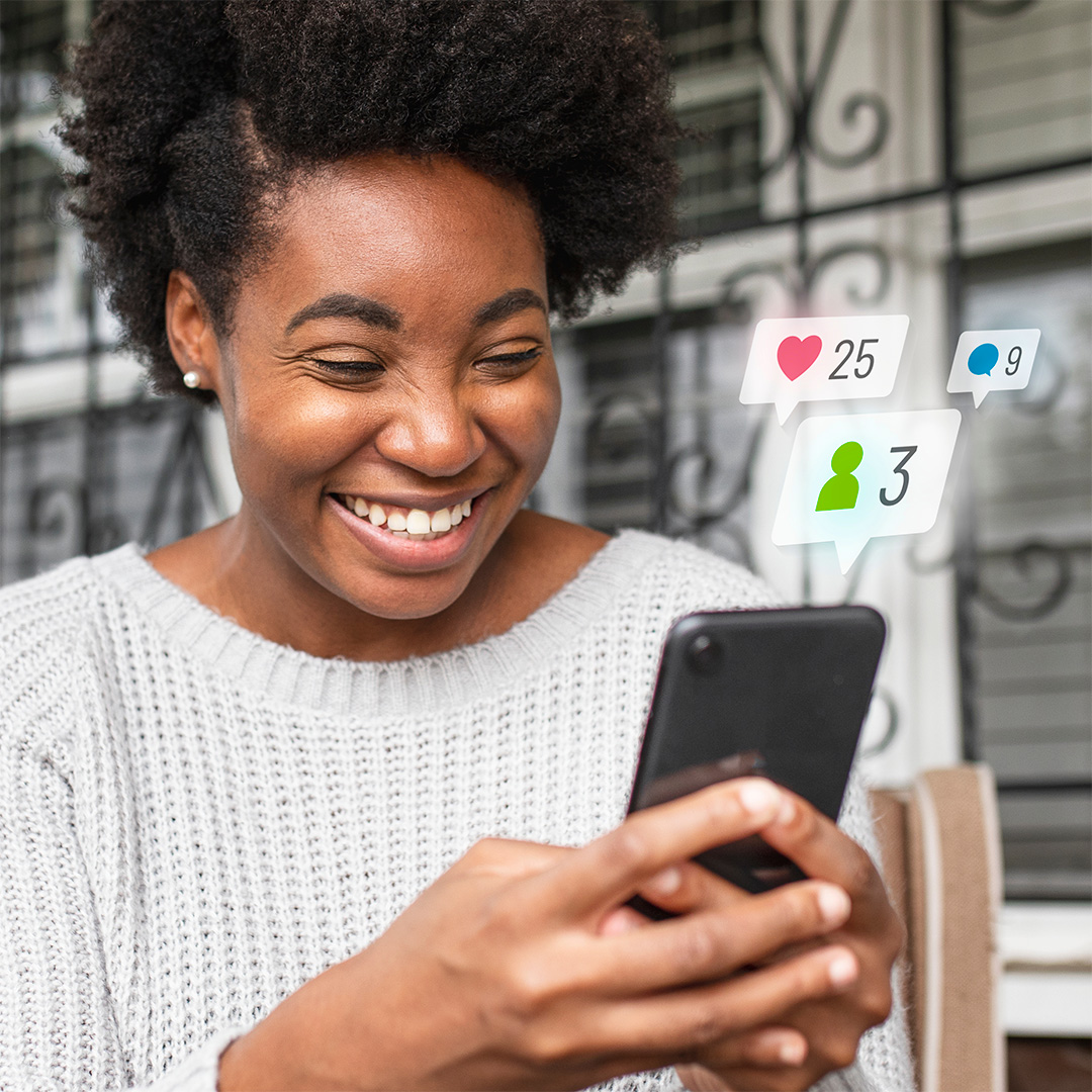 woman looking at her phone and smiling