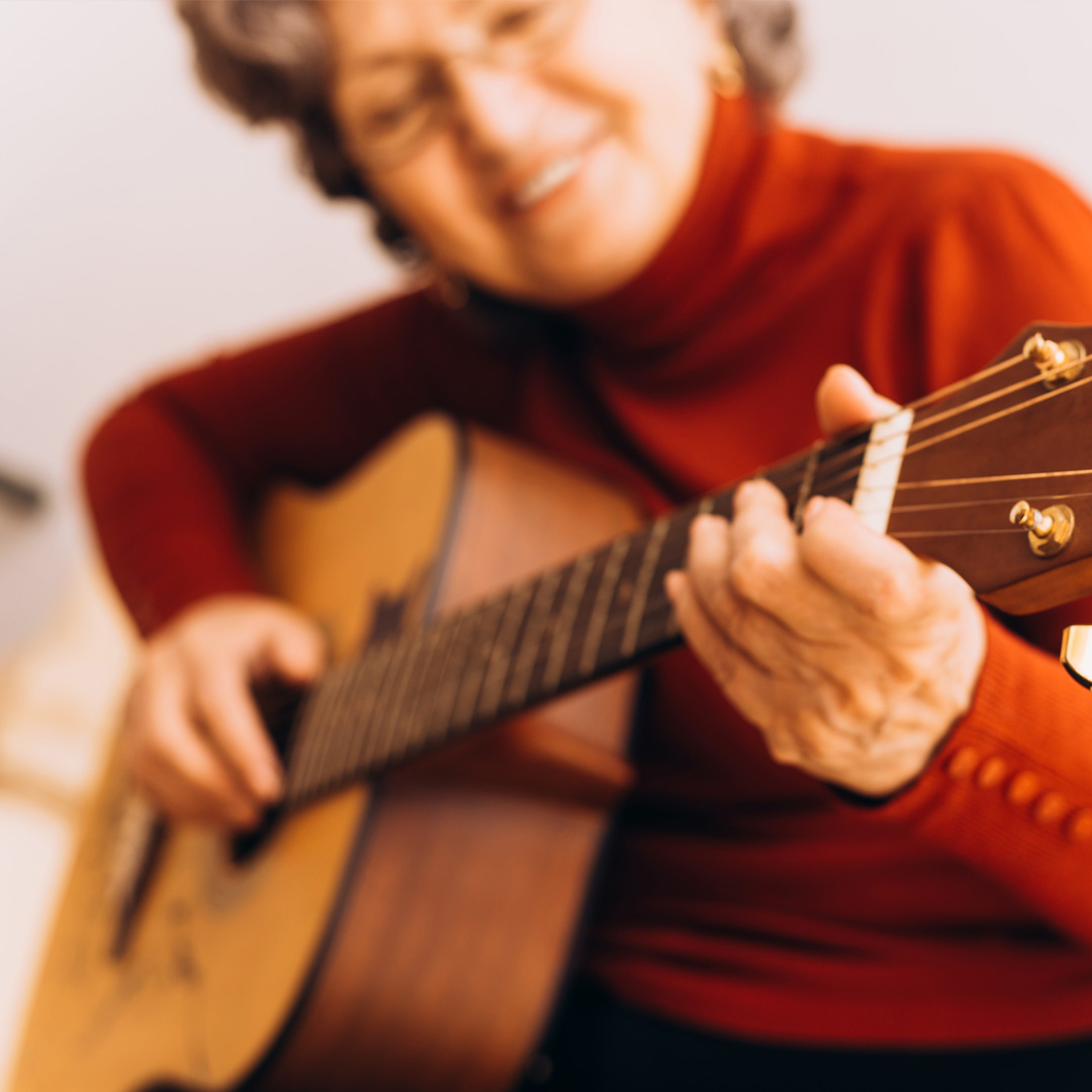 woman playing acoustic guitar