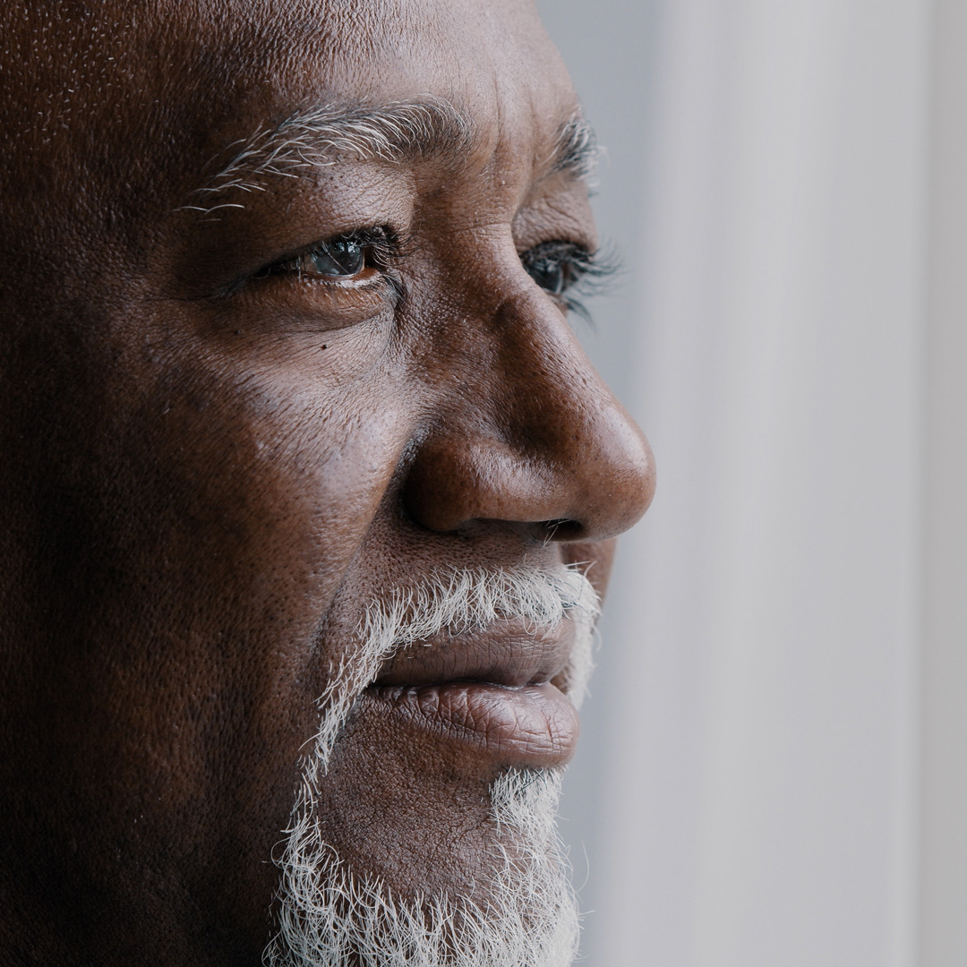 close-up of older man looking pensive