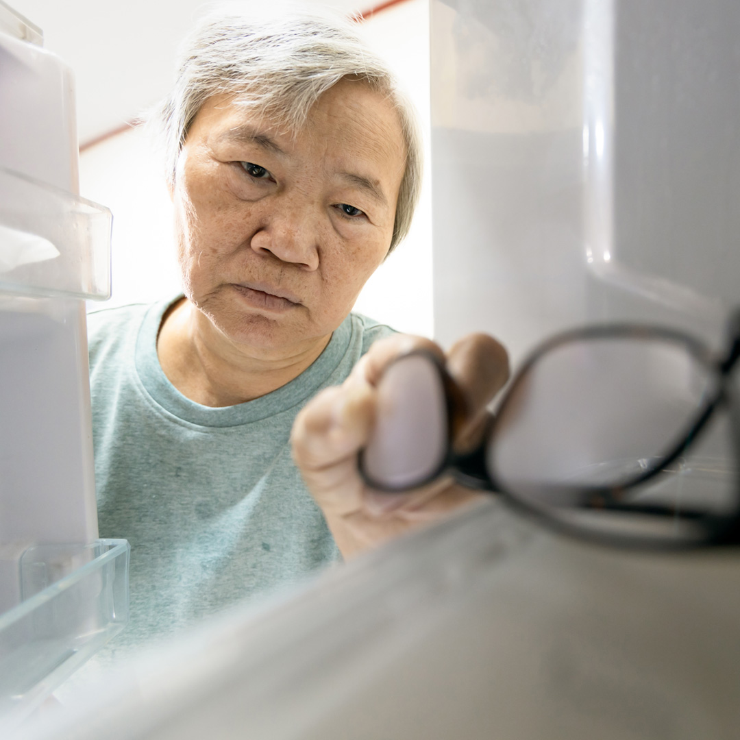 woman putting eyeglasses in freezer