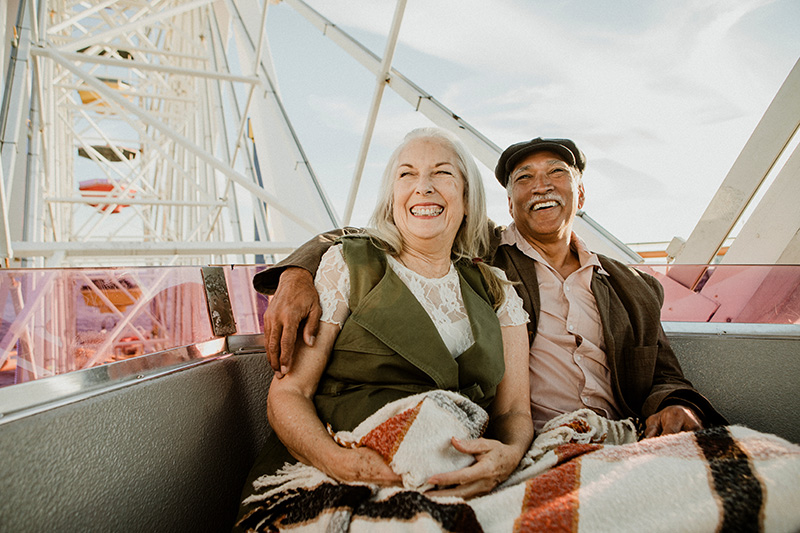 senior couple laughing on ferris wheel