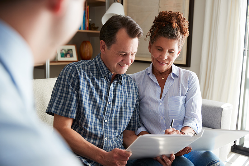 couple signing financial papers