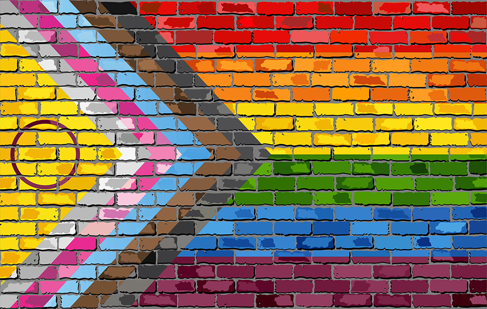 Illustration of the Progress Pride Flag painted on a brick wall