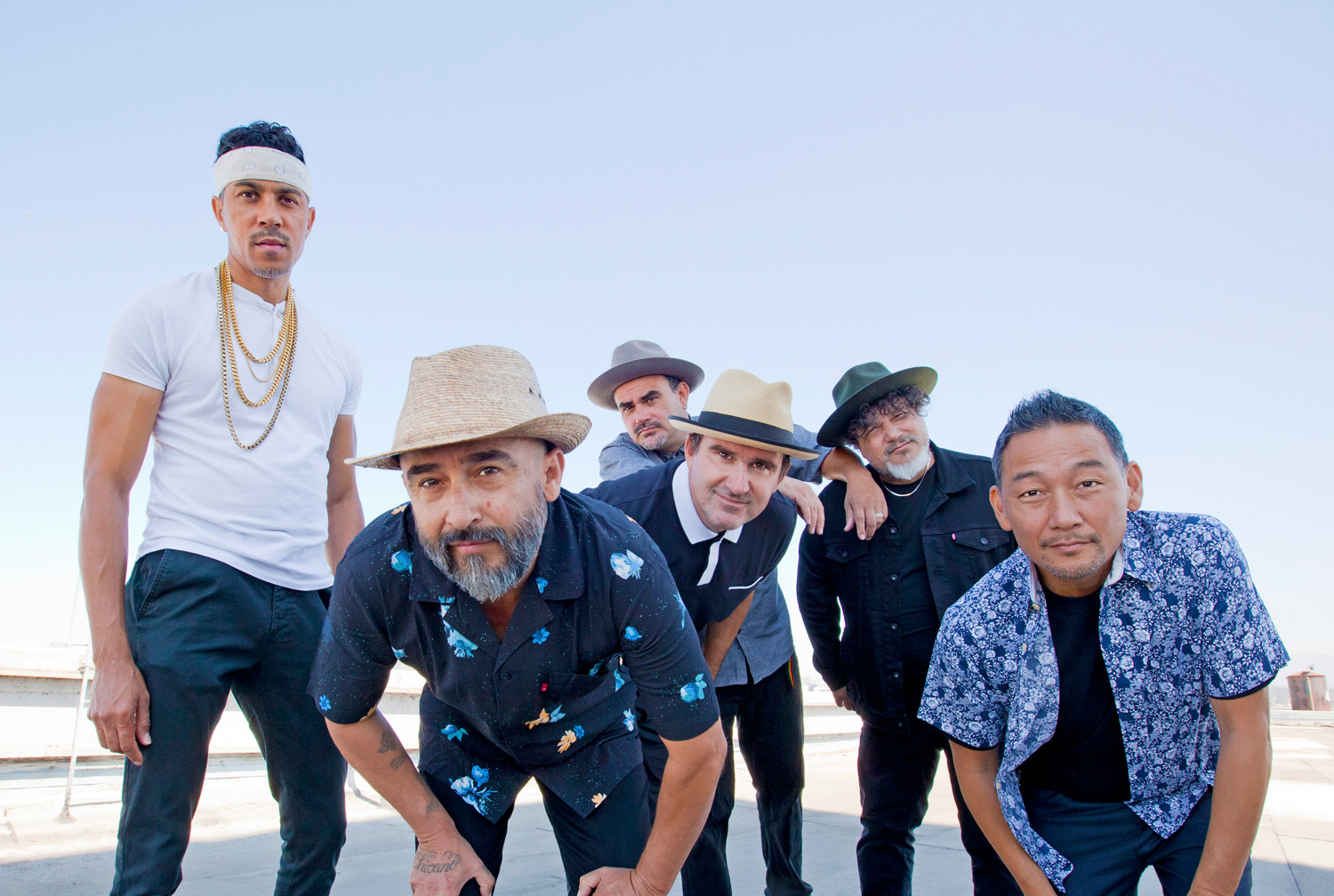 Ozomatli band members standing on building rooftop