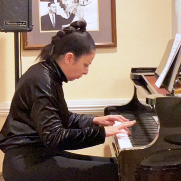 high school student playing piano for residents of an assisted living facility