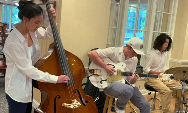 high school students playing music for residents of an assisted living facility