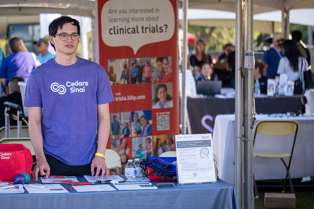 Person at the Cedars Sinai clinical trials booth