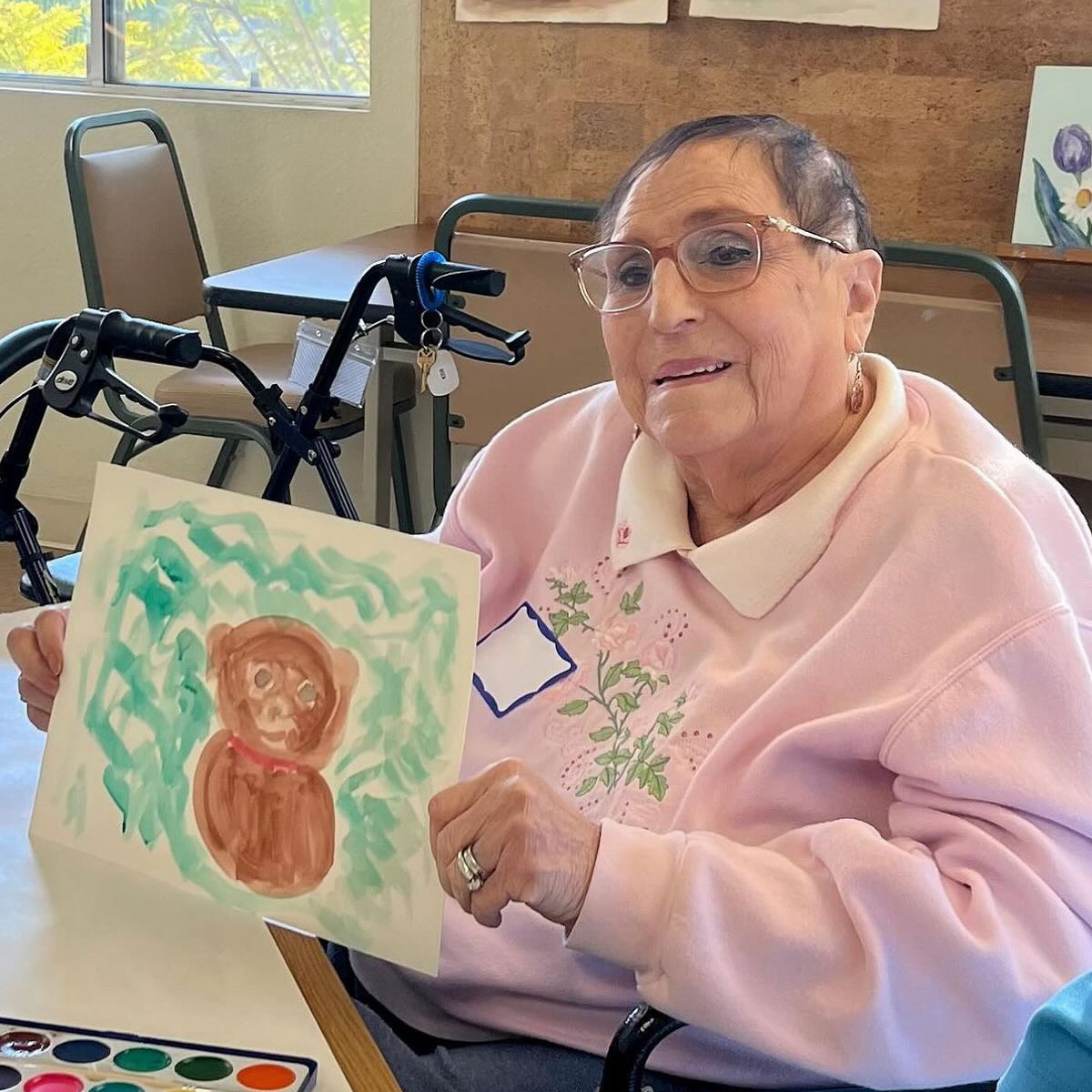 Memories in the Making participant holding up her painting