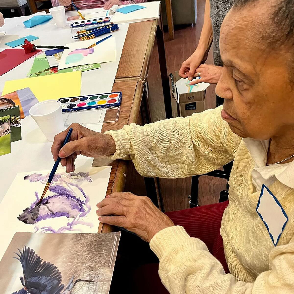 Memories in the Making participant painting with watercolor