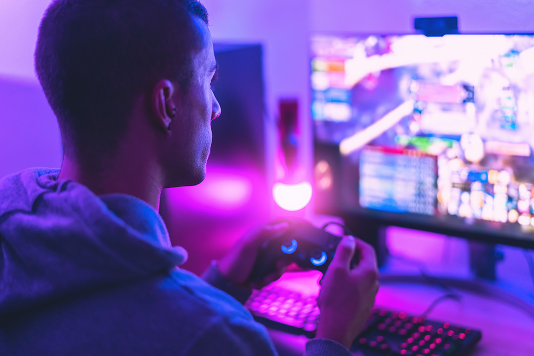 man playing video game on computer