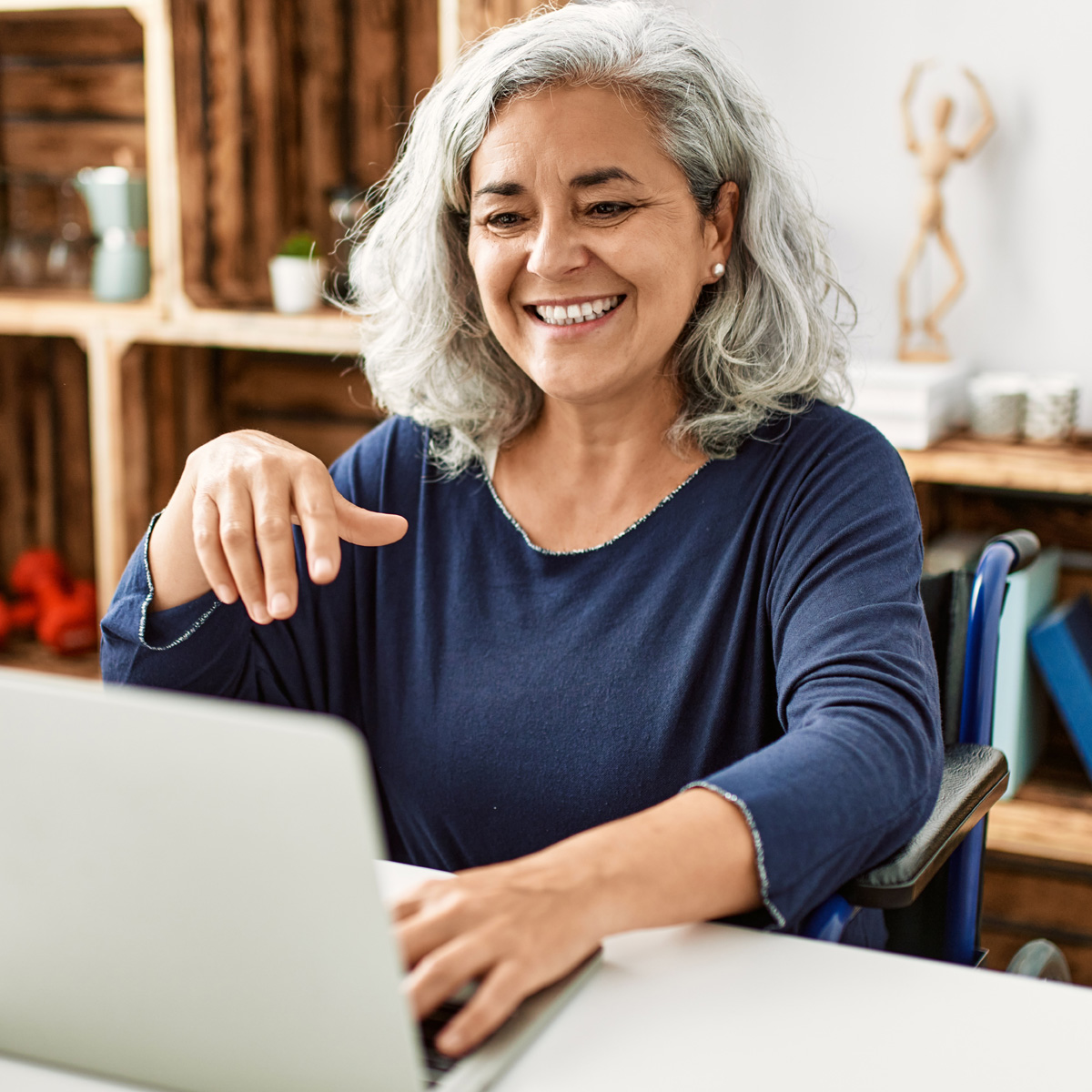 Woman looking at laptop screen and smiling