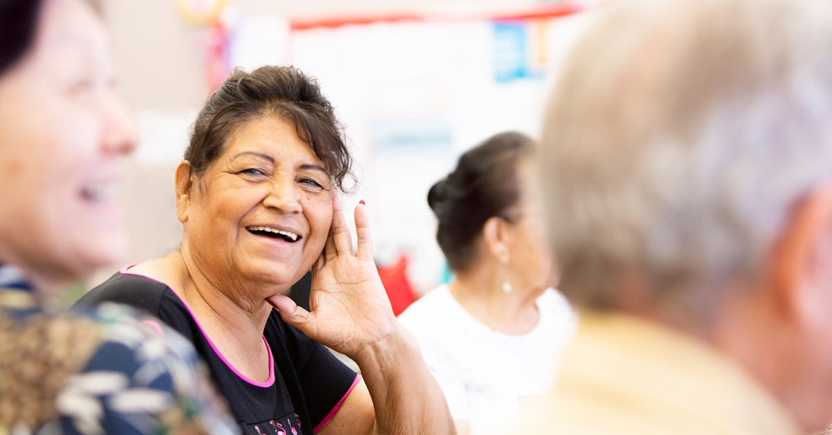 woman in a support group looking at camera and smiling