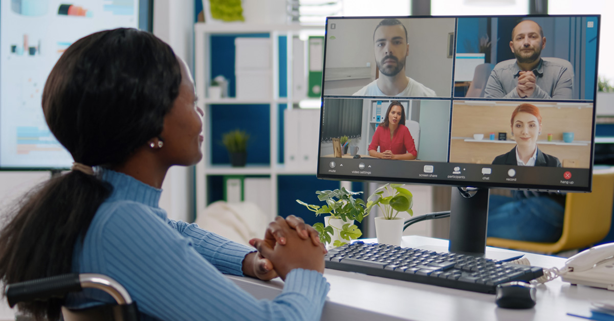 woman at home looking at her computer screen and attending a online workshop