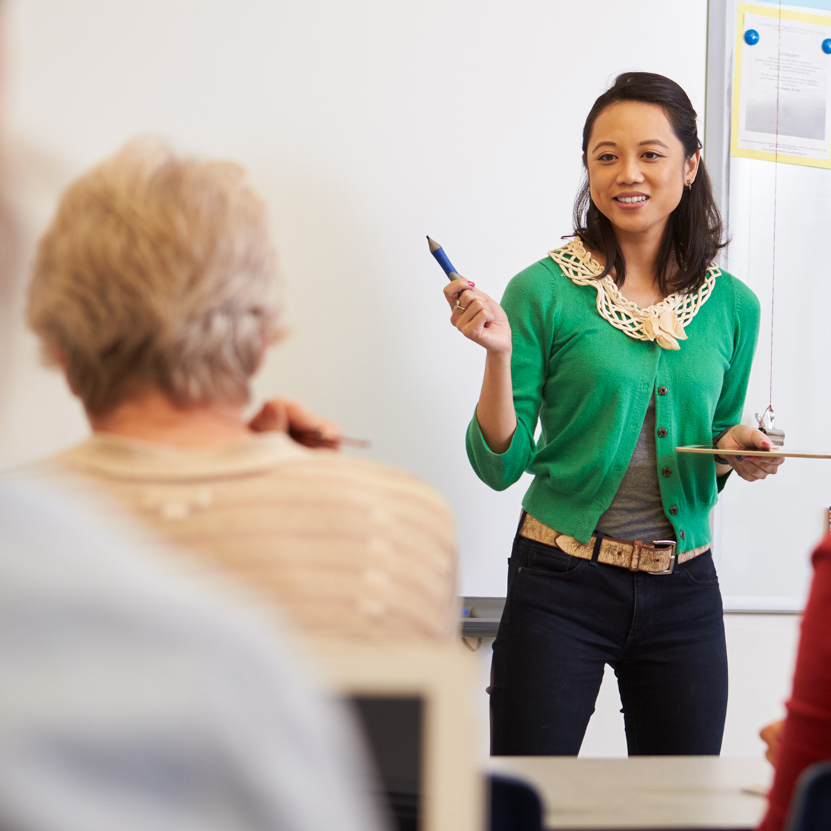 woman speaking to participants at a workshop