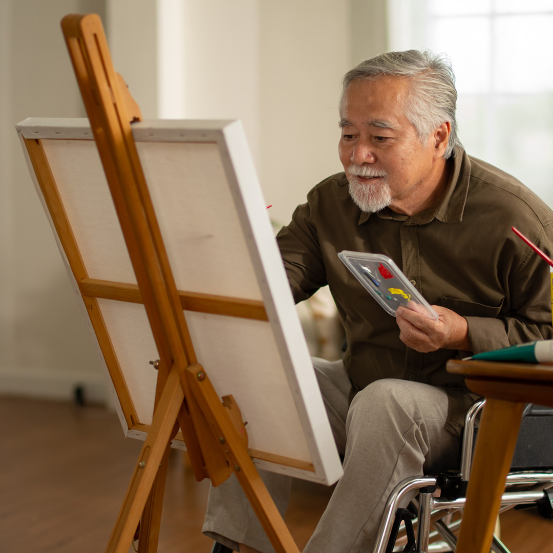 Man painting on an easel