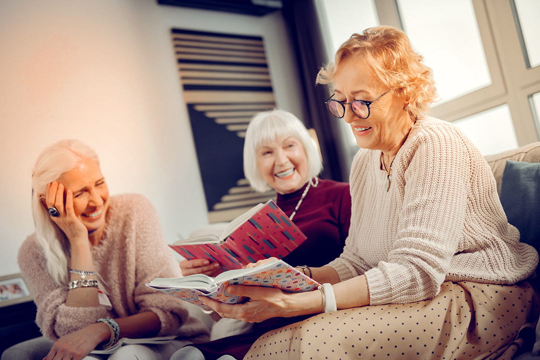 Care4ALZ-book-club three women laughing at a book club meeting