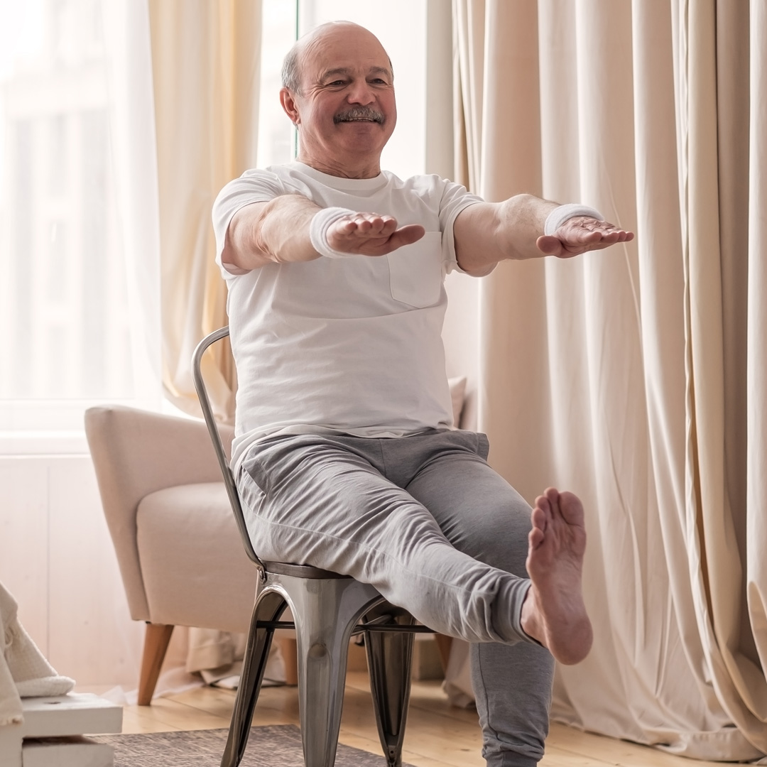 man stretching during chair yoga class