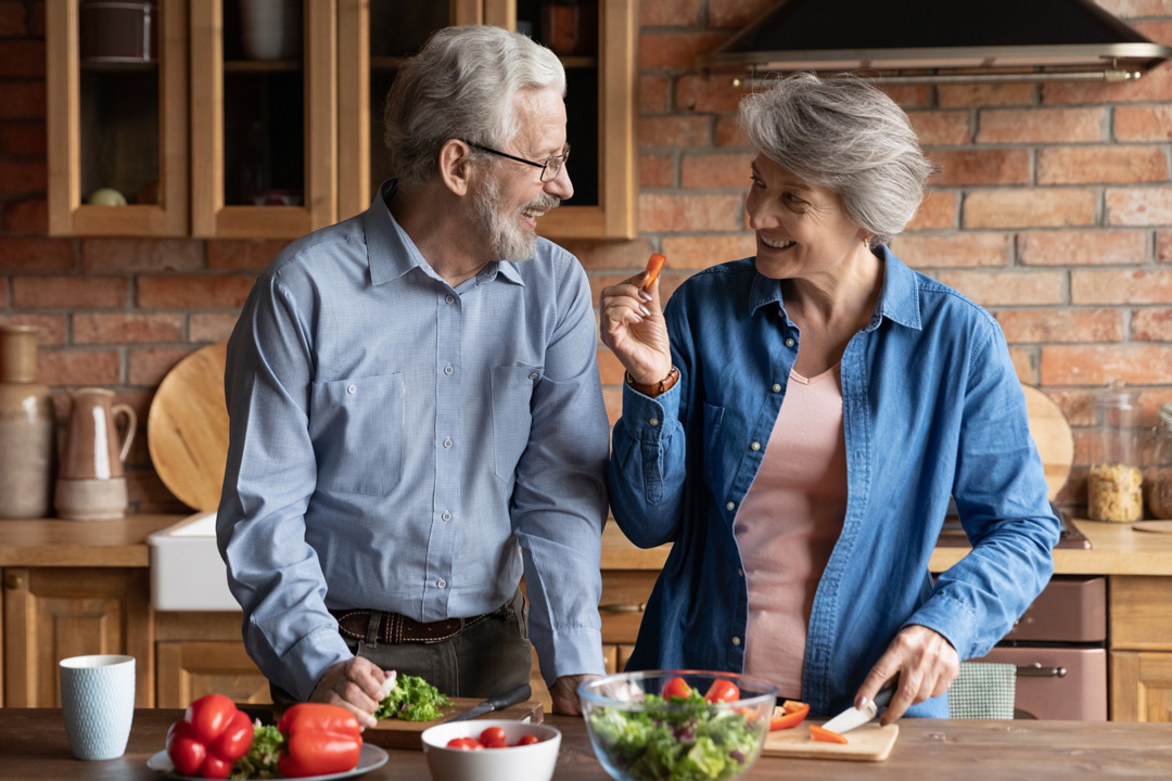 Care4ALZ-mediterranean-diet couple cutting vegetables in kitchen