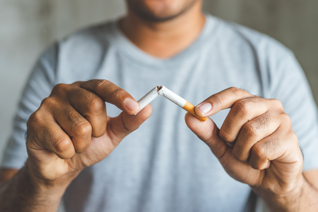 Care4ALZ-quit-smoking man tearing a cigarette in half
