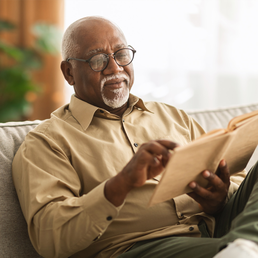Care4ALZ-read man reading a book at home